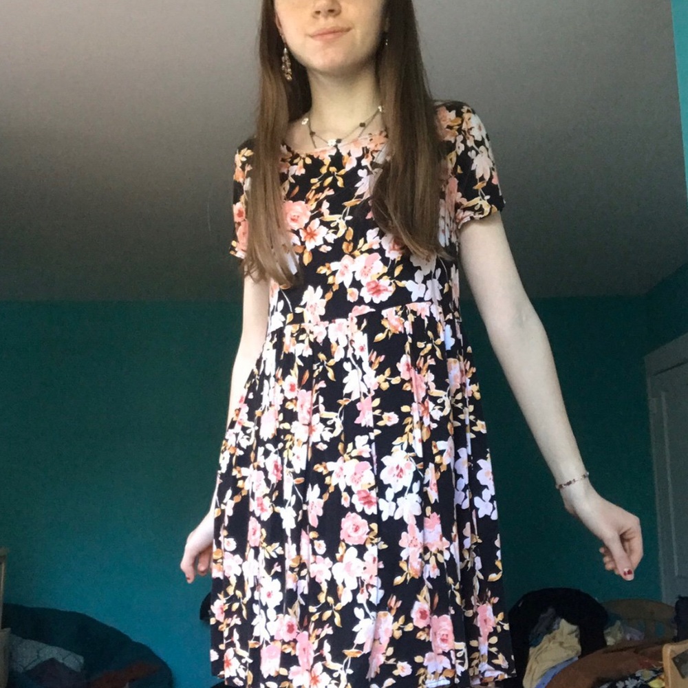 Black flowy dress with large pink flowers.